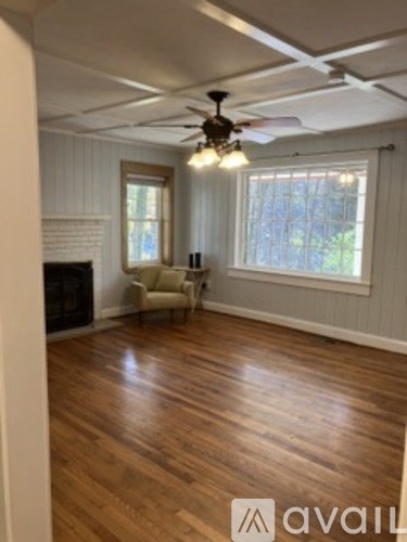 A room with wooden floors and a ceiling fan.