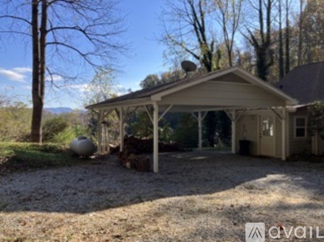 A house with a covered patio and a satellite dish on the roof.