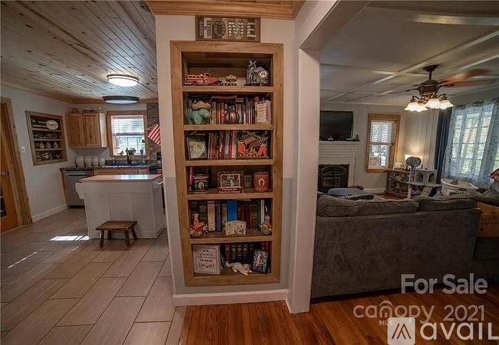 A living room with a bookshelf filled with books and a couch.