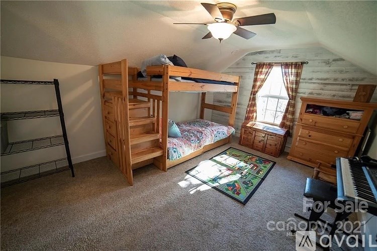 A room with a bunk bed, a chair, a dresser, and a piano is for sale.