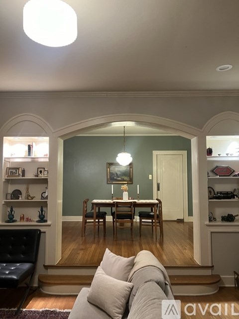 A living room with a couch and a dining table.