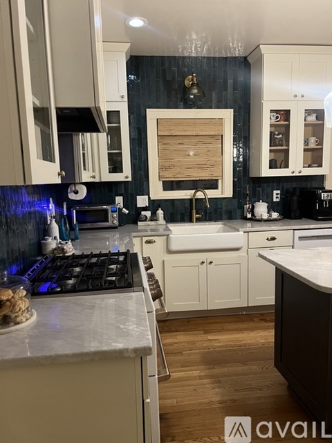 A kitchen with a stove top oven and a sink.