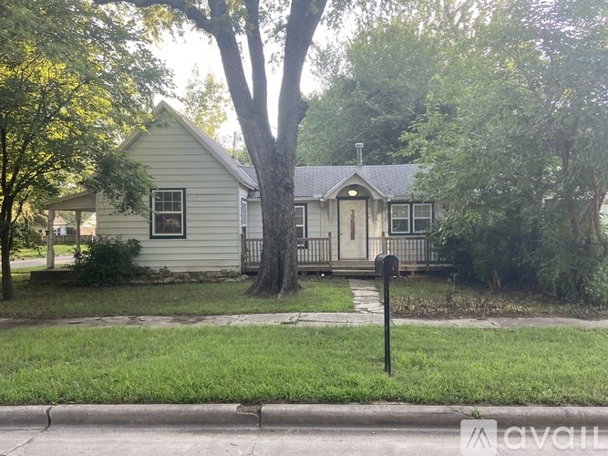 A house with a tree in front of it.