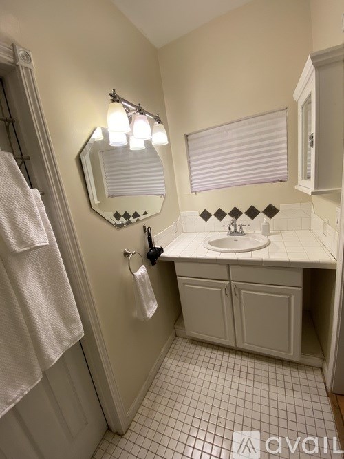 A bathroom with a white towel hanging on the door.