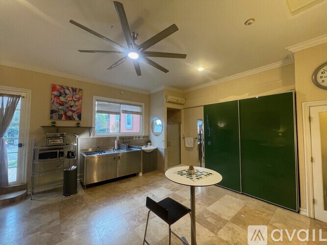 A kitchen with a table and chairs in the middle of the room.