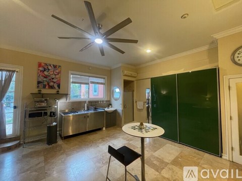 A kitchen with a table and chairs in the middle of the room.