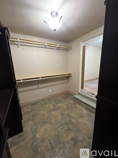 A room with a tiled floor and a mirror on the wall.