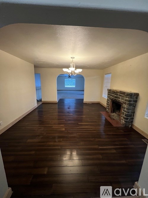 A long hallway with a fireplace on the right side.
