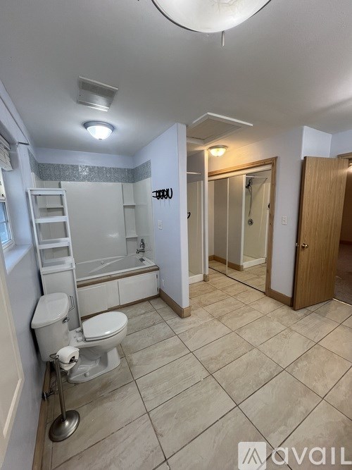 A bathroom with a toilet, sink, and bathtub.