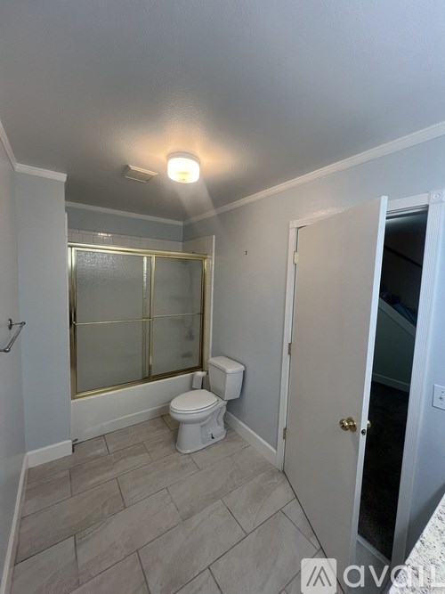 A bathroom with a toilet, sink, and shower.