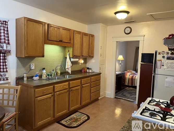 A kitchen with wooden cabinets and a black stove top.
