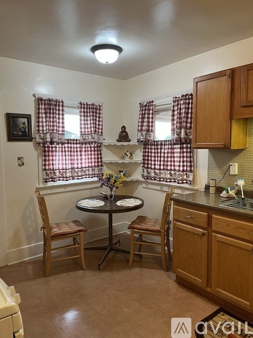 A small kitchen with a table and chairs.