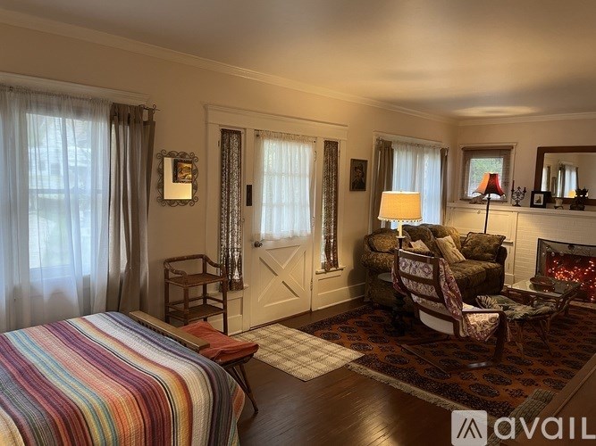 A well-lit, cozy living room with a striped bedspread.