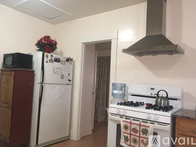 A kitchen with a white fridge, a white stove and a white oven.
