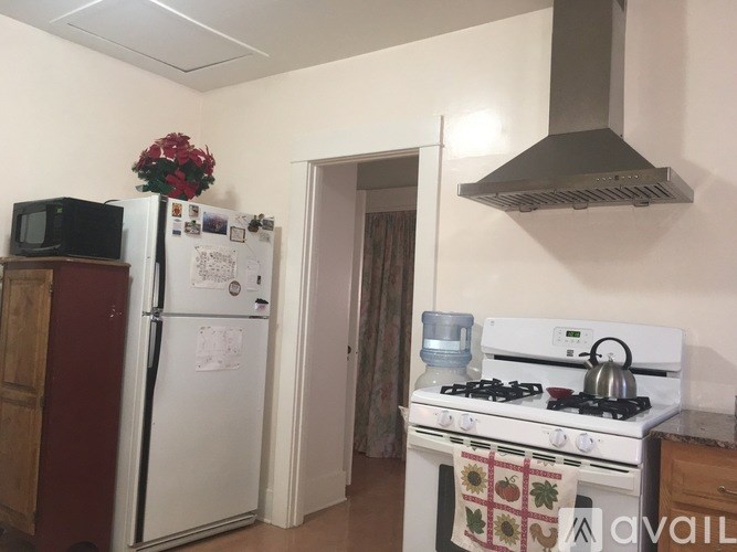 A kitchen with a white fridge, a white stove and a white oven.
