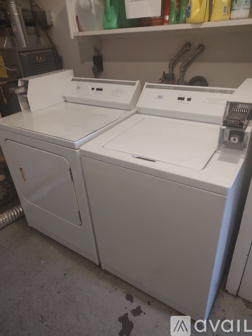 A white dryer is sitting in a room.