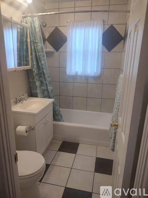 A bathroom with a toilet, sink, and bathtub.