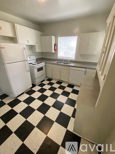 A kitchen with black and white checkered floor.