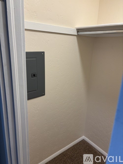 A wall-mounted electrical switch is on a beige wall.