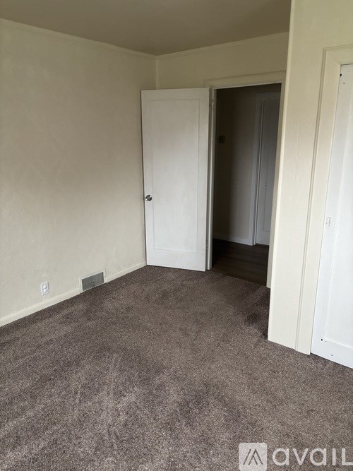A room with a concrete floor and a window on the wall.