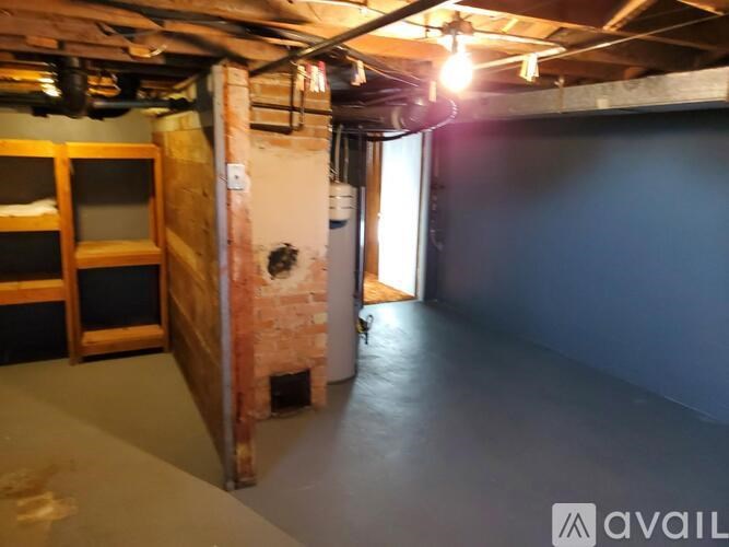 A room with a brick wall and a doorway leading to another room.