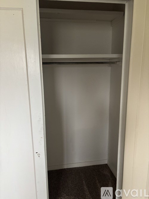 A room with wooden walls and a brown door.