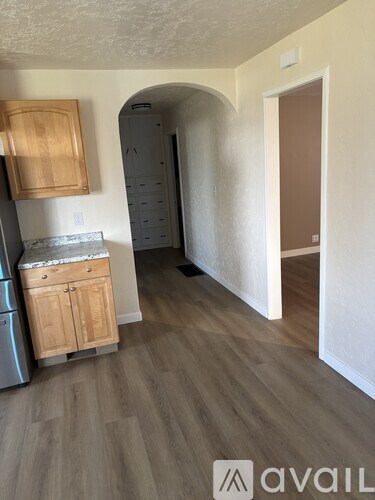 A kitchen with wooden cabinets and a marble countertop.
