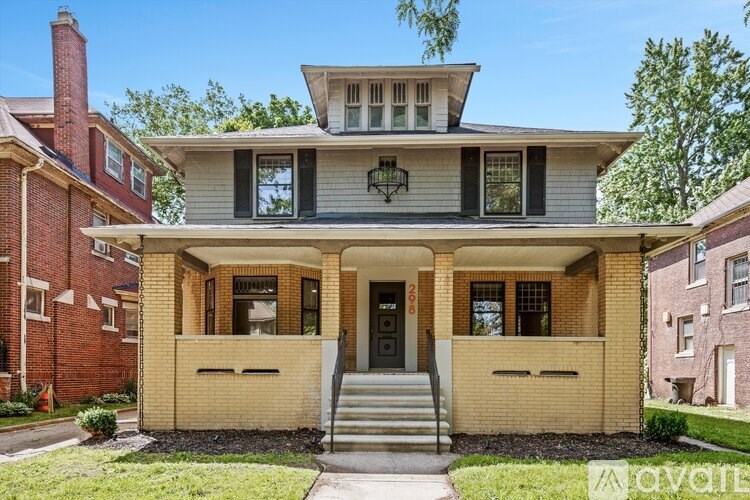 A house with a front porch and a black door.
