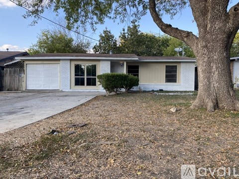 A house with a tree in front of it.
