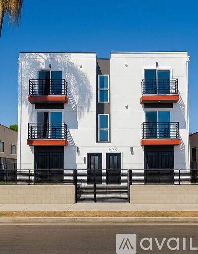A white building with black railings and red accents.