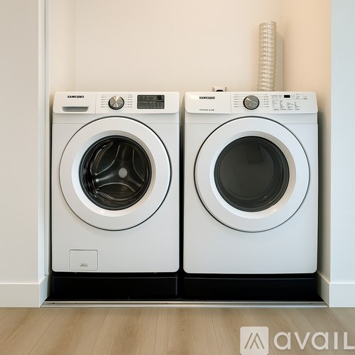 Two Samsung front loading washing machines in a laundry room.