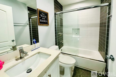 A bathroom with a sink, toilet, and shower.
