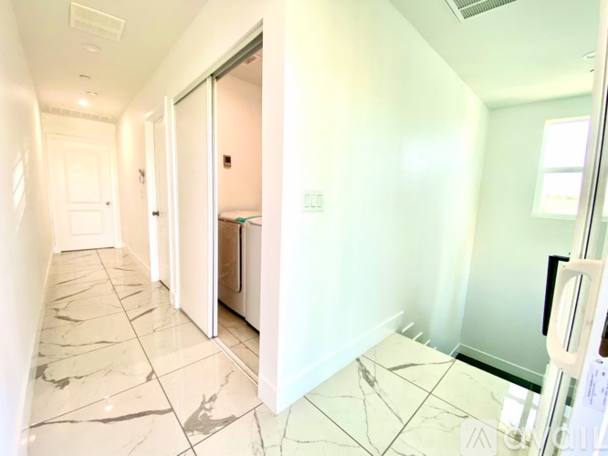 A hallway with marble tiles on the floor.