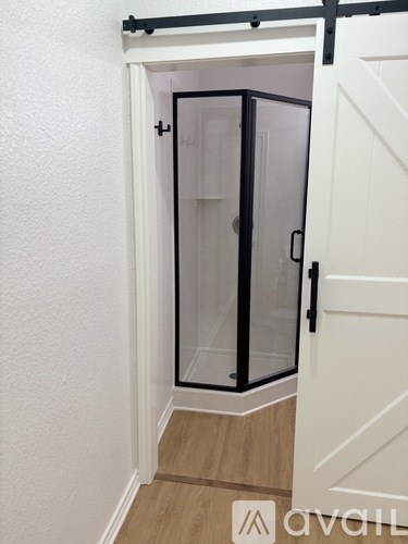 A white door with a black handle and a glass panel.