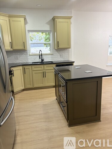 A kitchen with wooden cabinets and a black countertop.