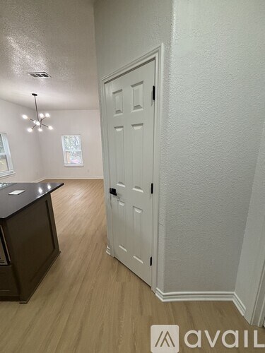 A white door is in a room with a brown counter.