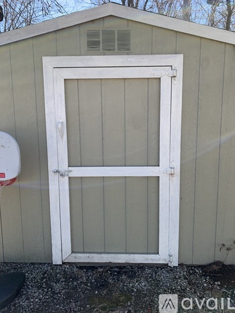 A white door is on a tan building.