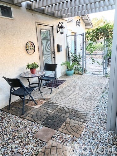 A patio with a table and chairs.
