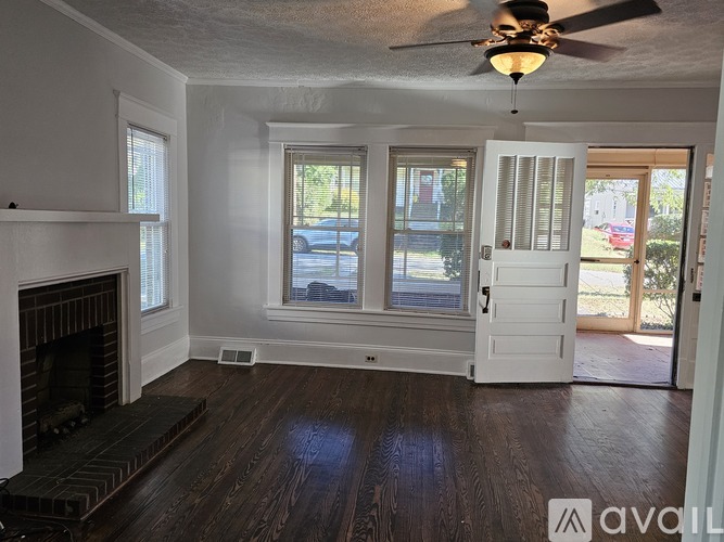 A room with a fireplace and a ceiling fan.