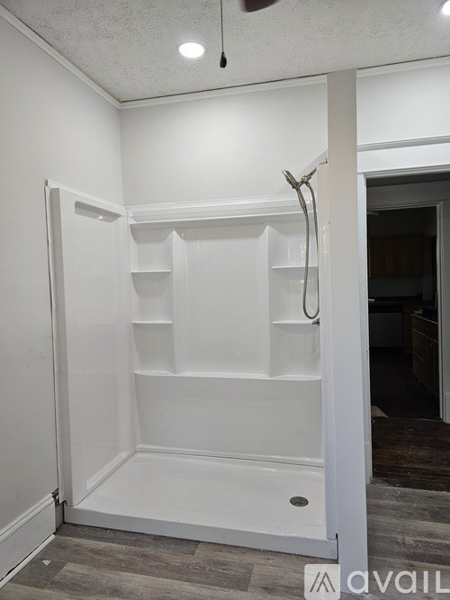 A white closet with a hanger on the shelf.
