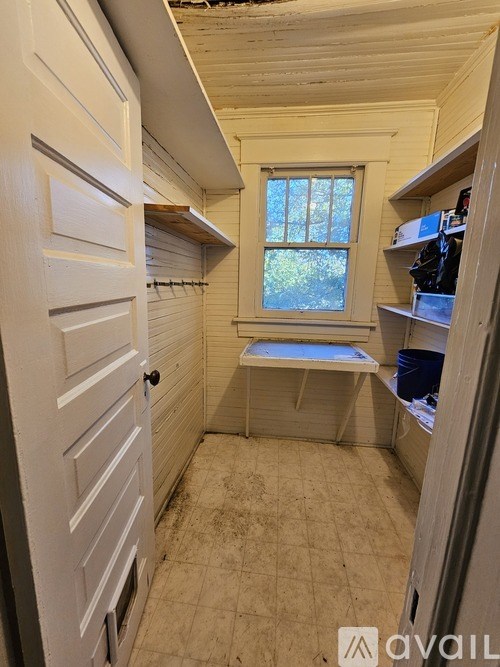 A small room with a window and a door.