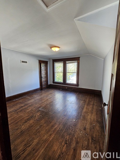 A room with wooden floors and a skylight.