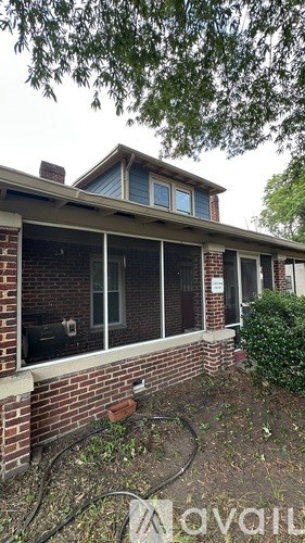 A house with a brick wall and a window.