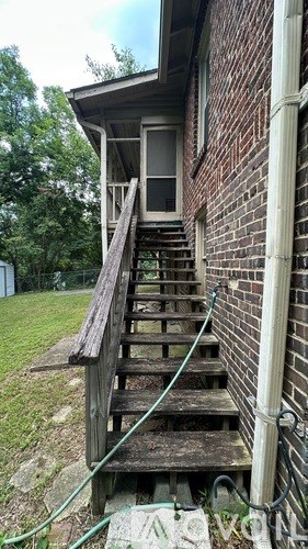 A wooden staircase with a green hose attached to it.