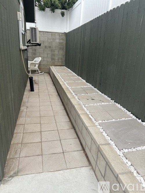 A bathroom with a tiled floor and a bench.