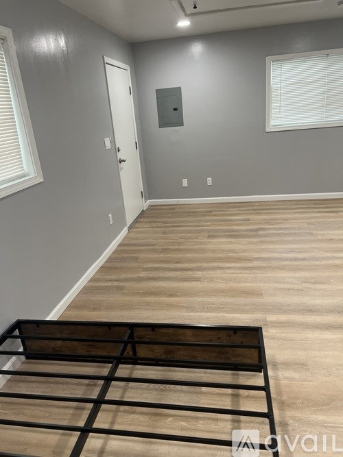 A room with a wooden floor and a white door.