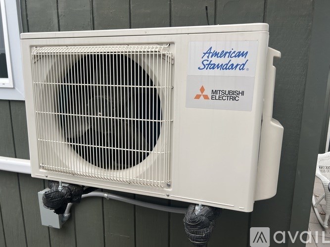 A Mitsubishi Electric air conditioner unit is mounted on a wall.