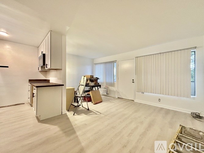 A room with a desk, chair, and a cabinet.