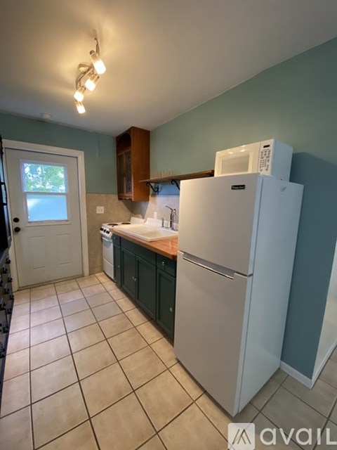A kitchen with a white refrigerator and a white dishwasher.