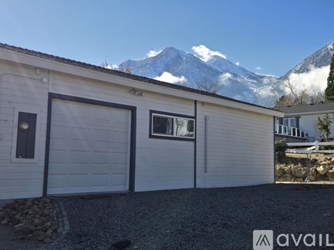 A house with a mountain in the background and a sign that says "available".